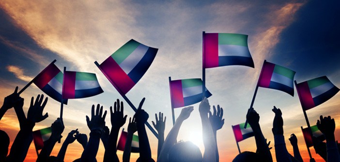 Hands holding up UAE flag